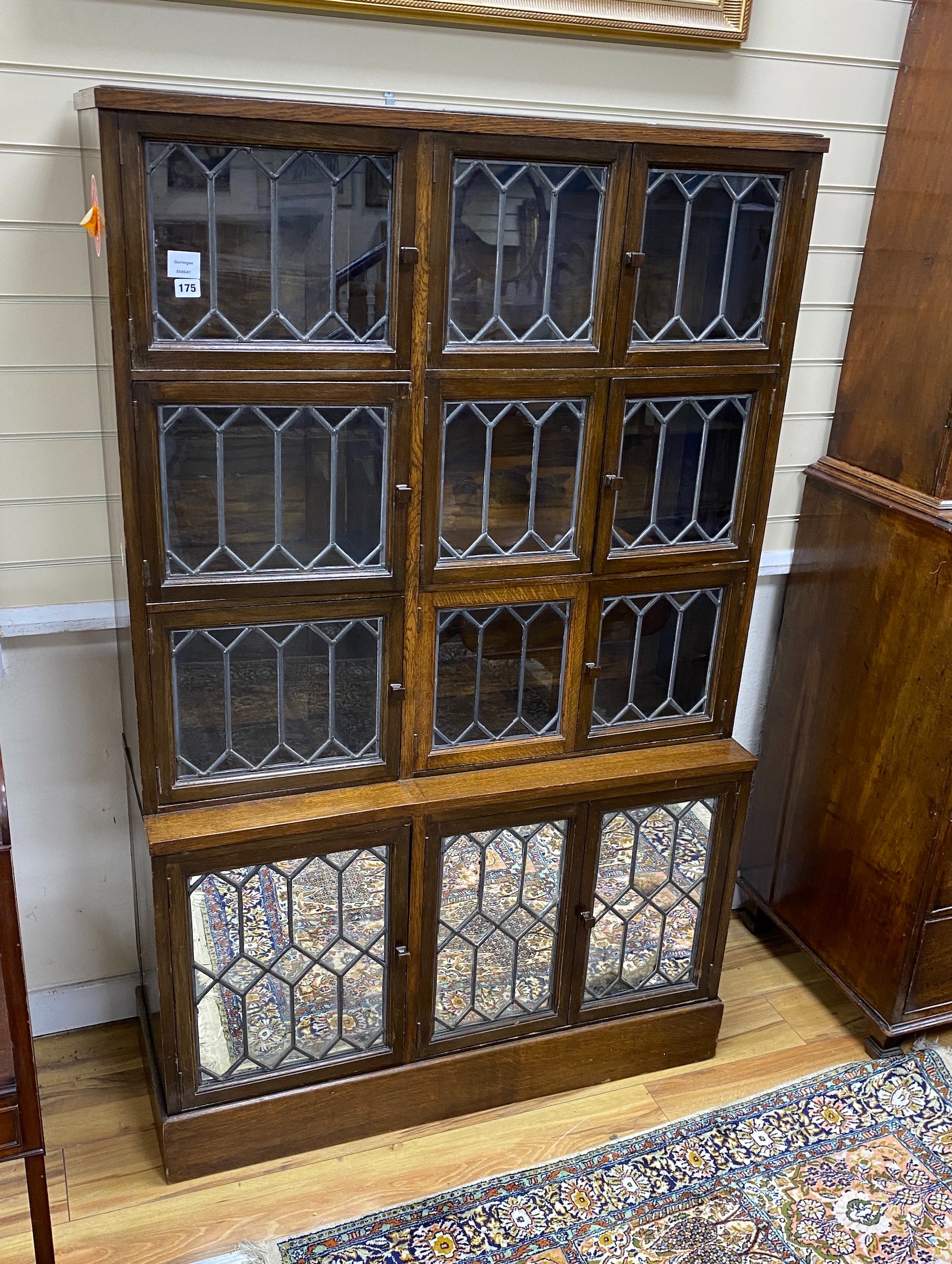 A Globe Wernicke type oak sectional bookcase, enclosed by leaded glazed doors, width 103cm, depth 37cm, height 163cm